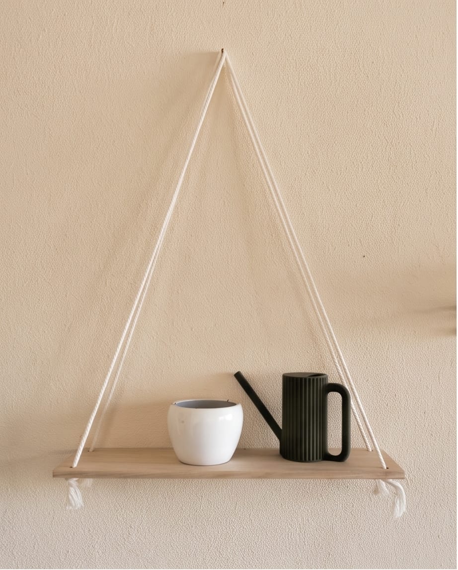 Black Teknospace watering can styled on a hanging shelf