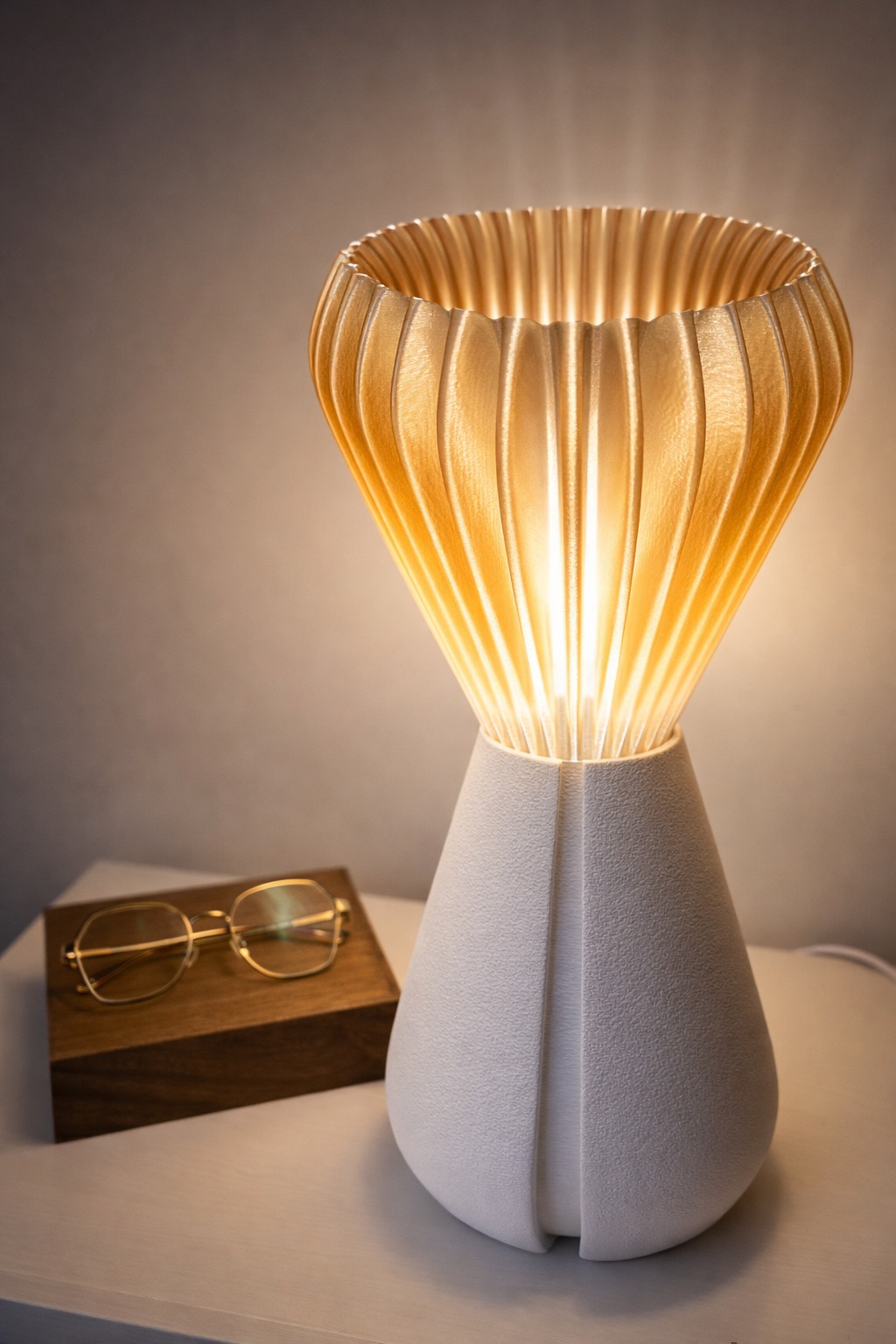 Sakumi 3D printed lamp glowing warmly on a bedside table