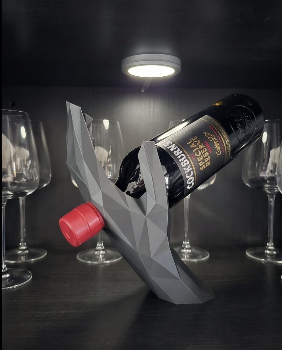 Sculptural hand wine holder displayed in a customer cabinet